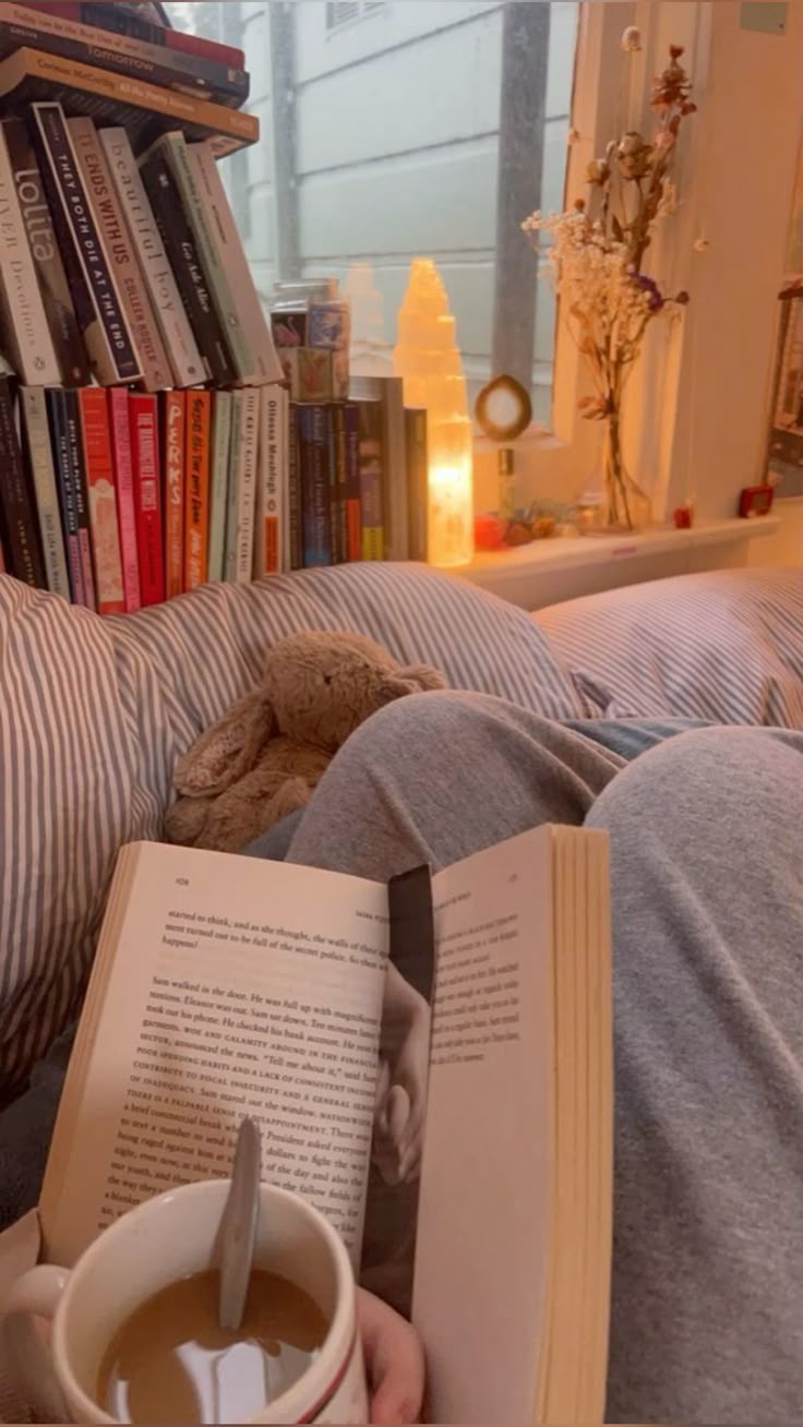Reader with coffee and a stack of books